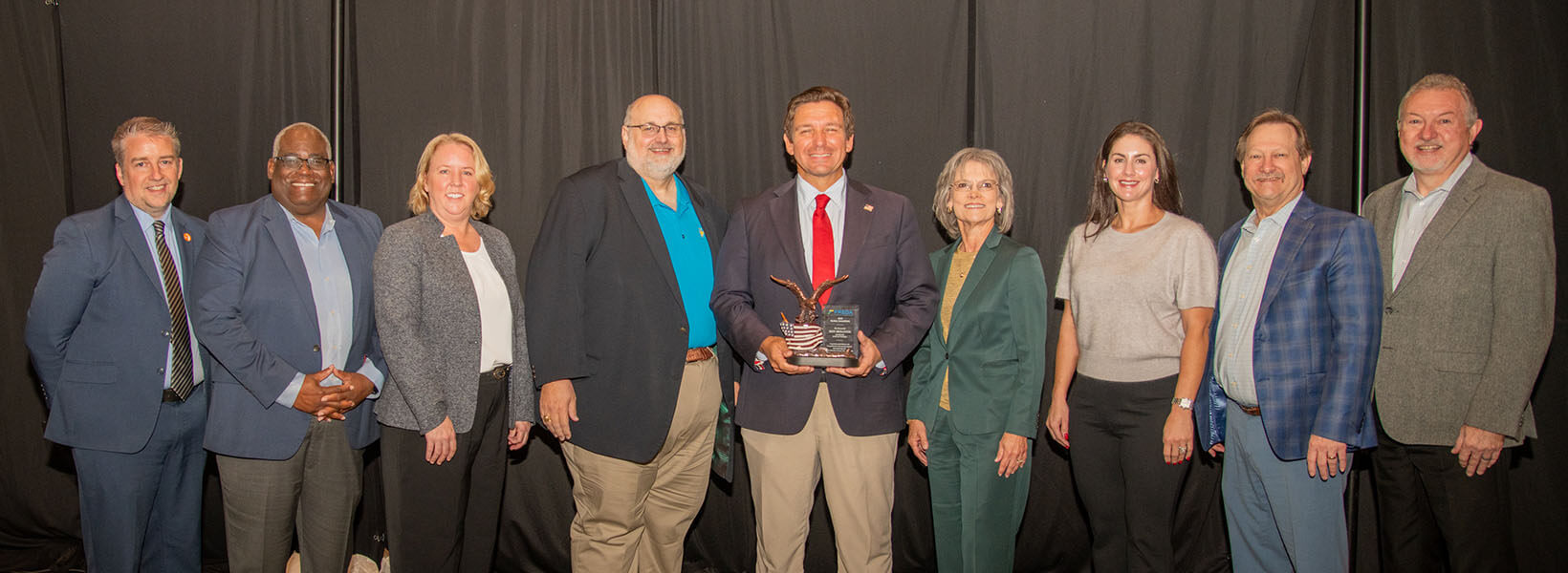 The FREDA board poses for a picture with the Governor