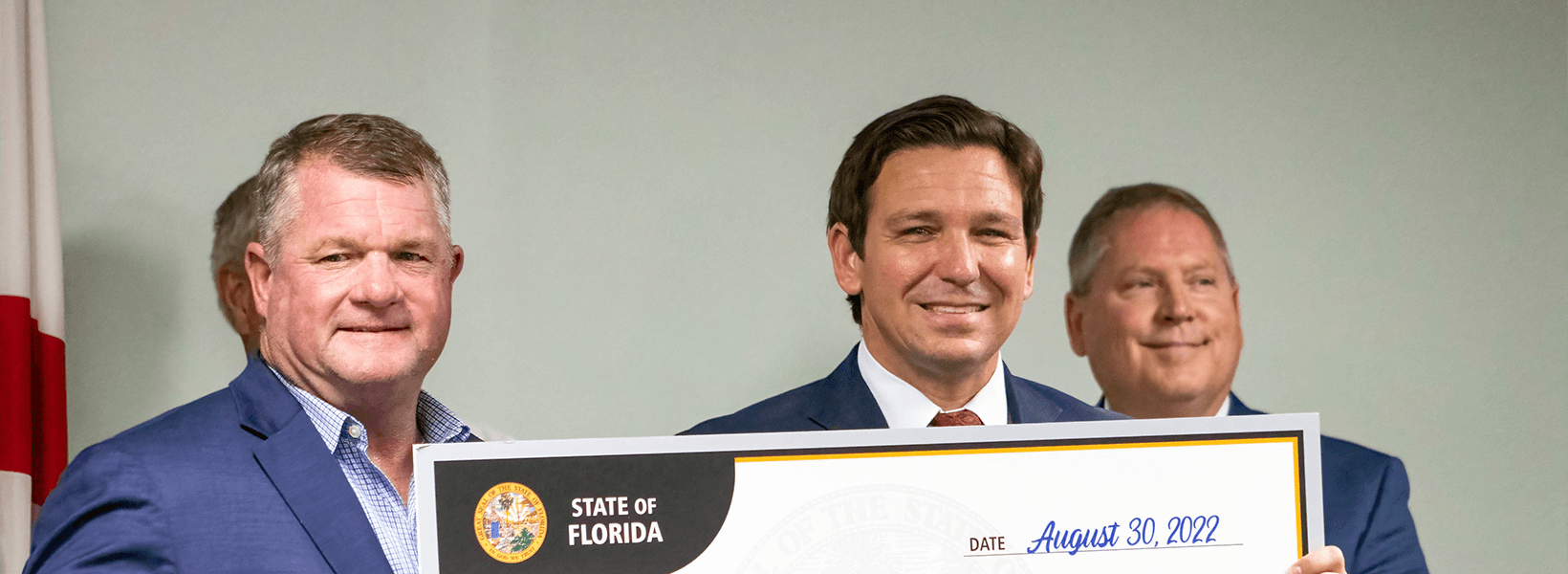Governor DeSantis presents a check to Suwannee County Chairman