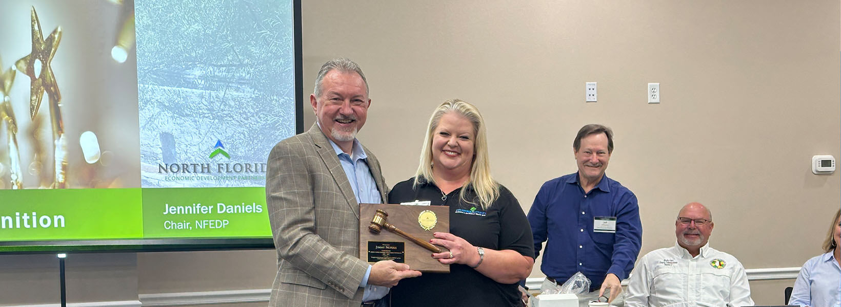 Norris accepts a plaque from NFEDP