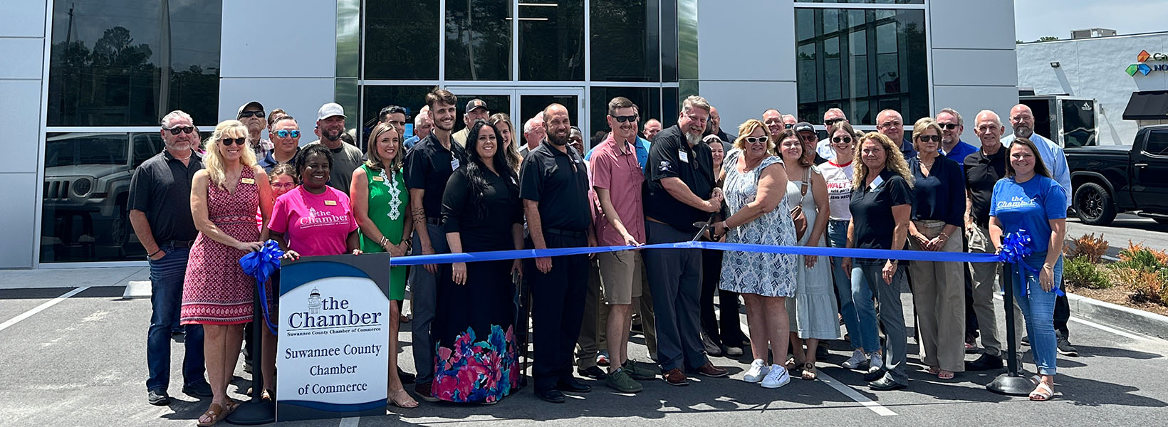 Group poses for a picture during a ribbon cutting